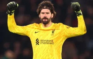 Alisson Becker - Portrait with yellow goalkeeper kit.